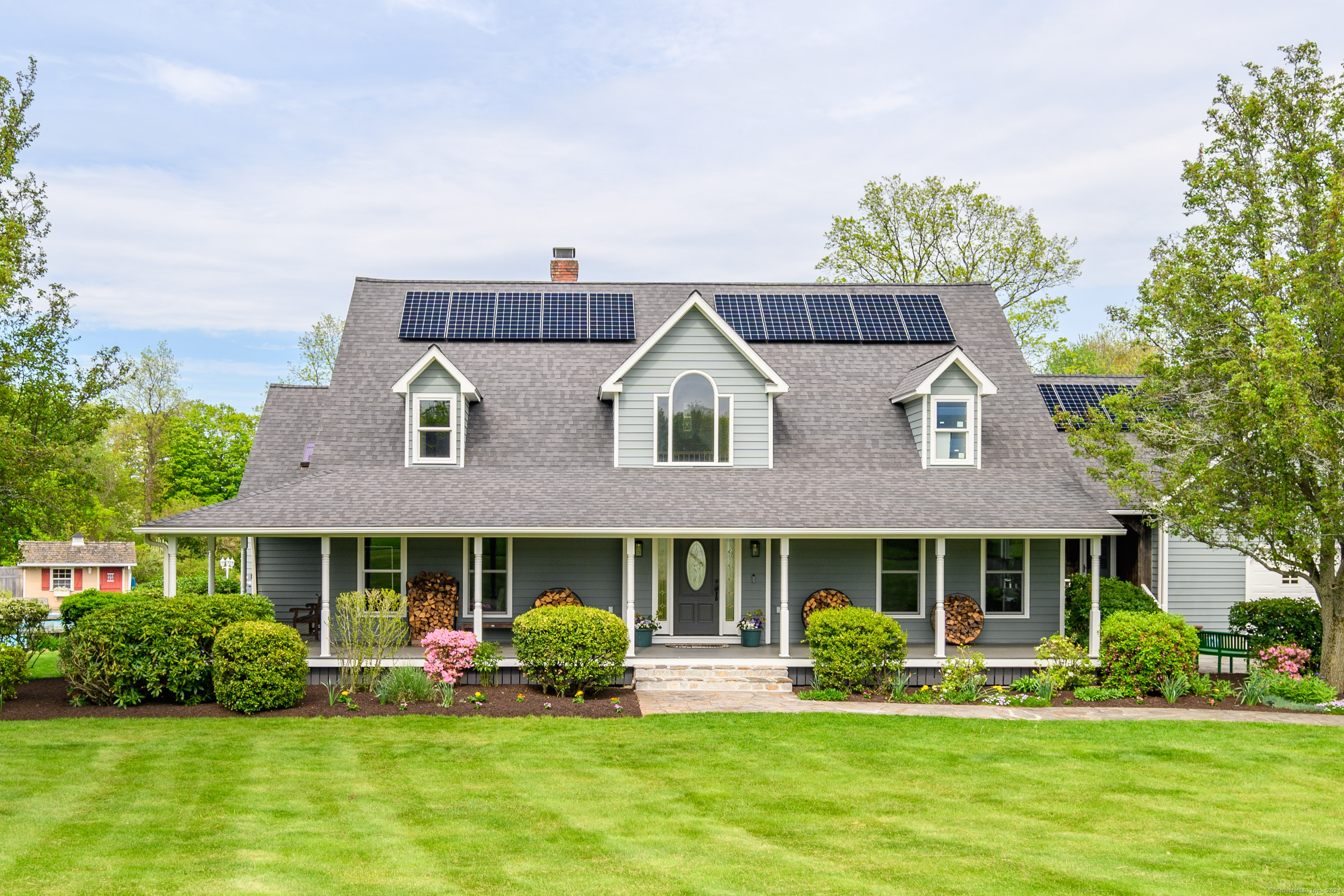 a front view of a brick house with a yard