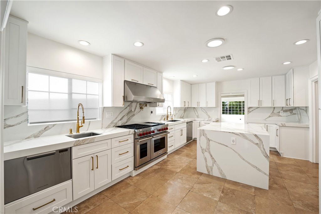 a kitchen with a sink stove top oven and cabinets