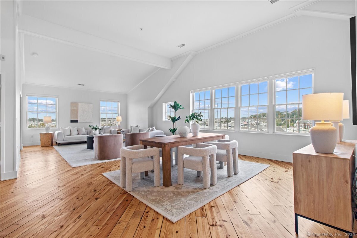 a view of a dining room with furniture and wooden floor