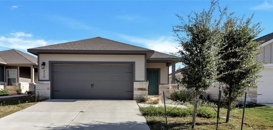 a front view of a house with a garage