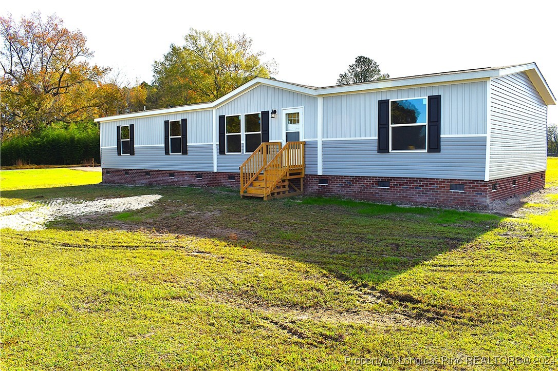 a view of a house with a yard patio and swimming pool