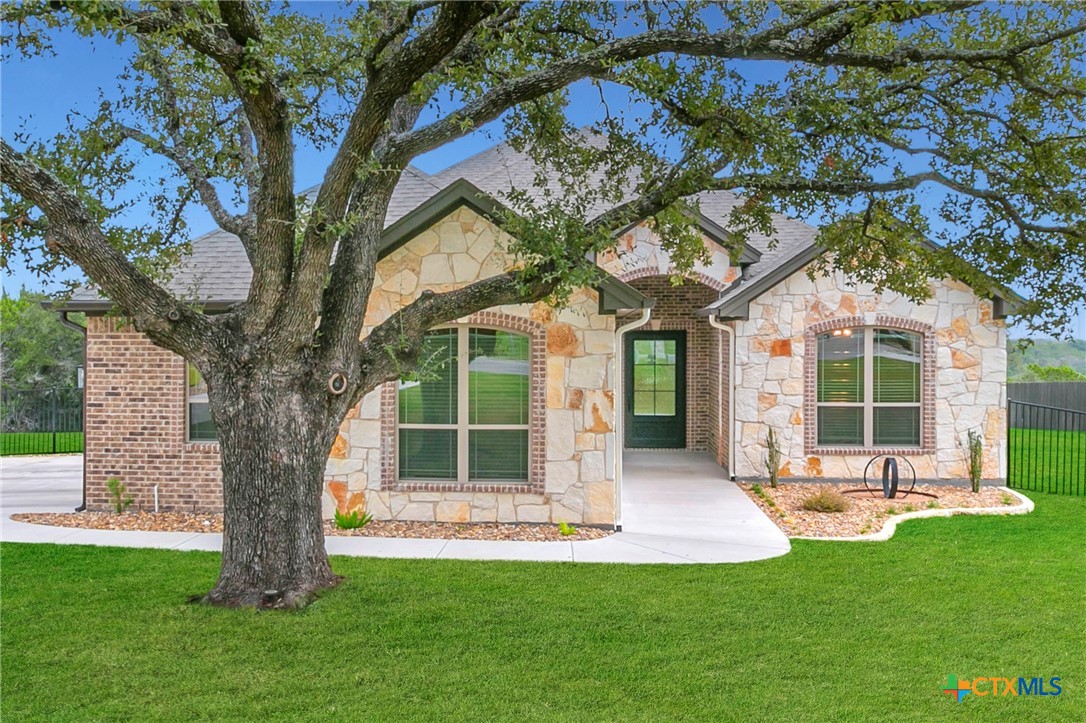 a porch with a tree in front of a house