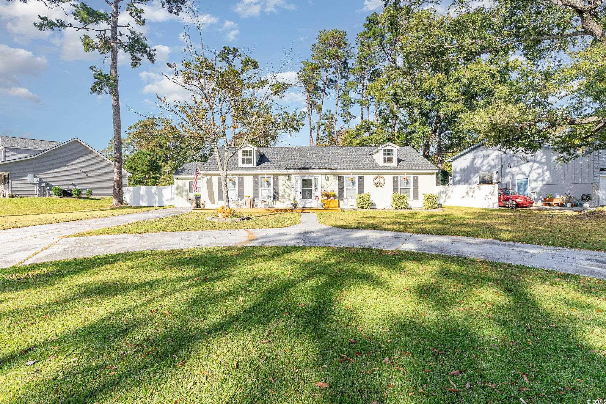 Cape cod house featuring a front yard