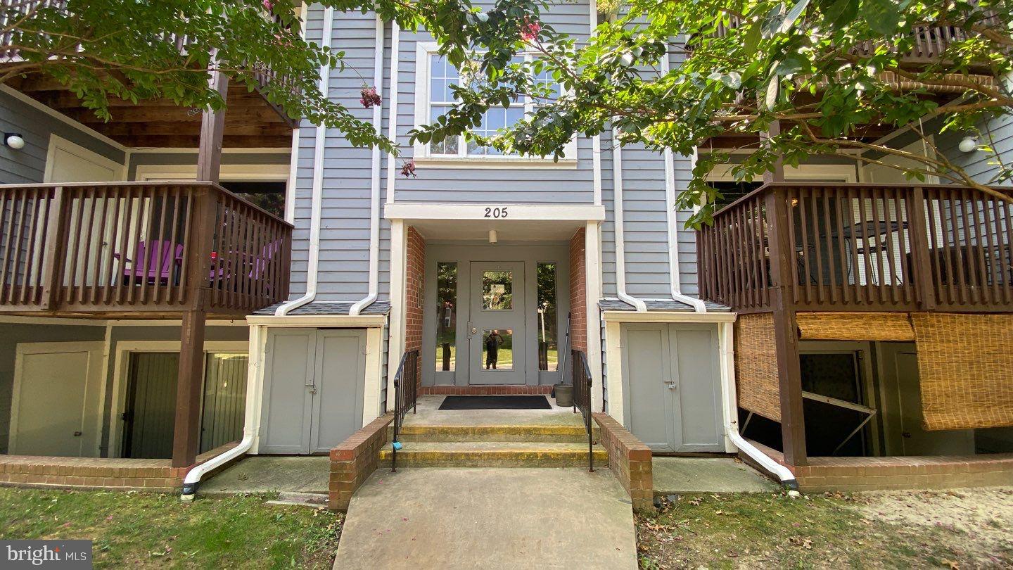 a view of entrance gate of house and car parked