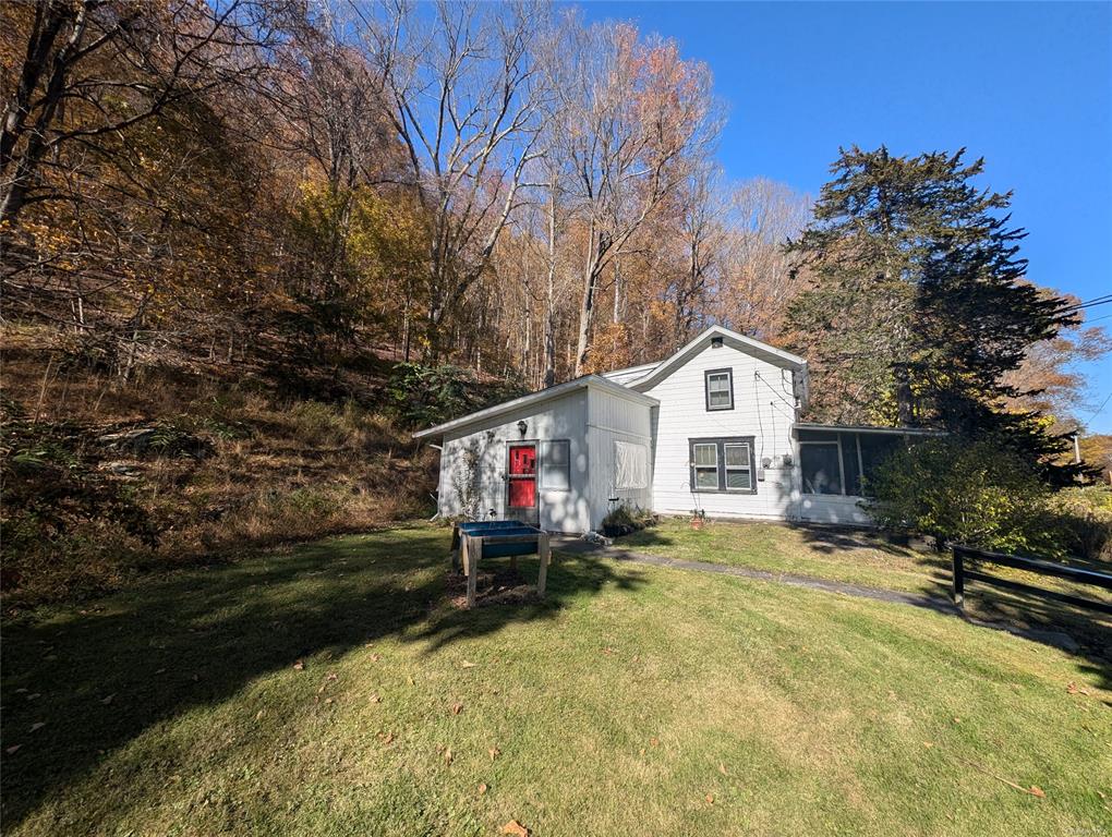 View of yard with a sunroom