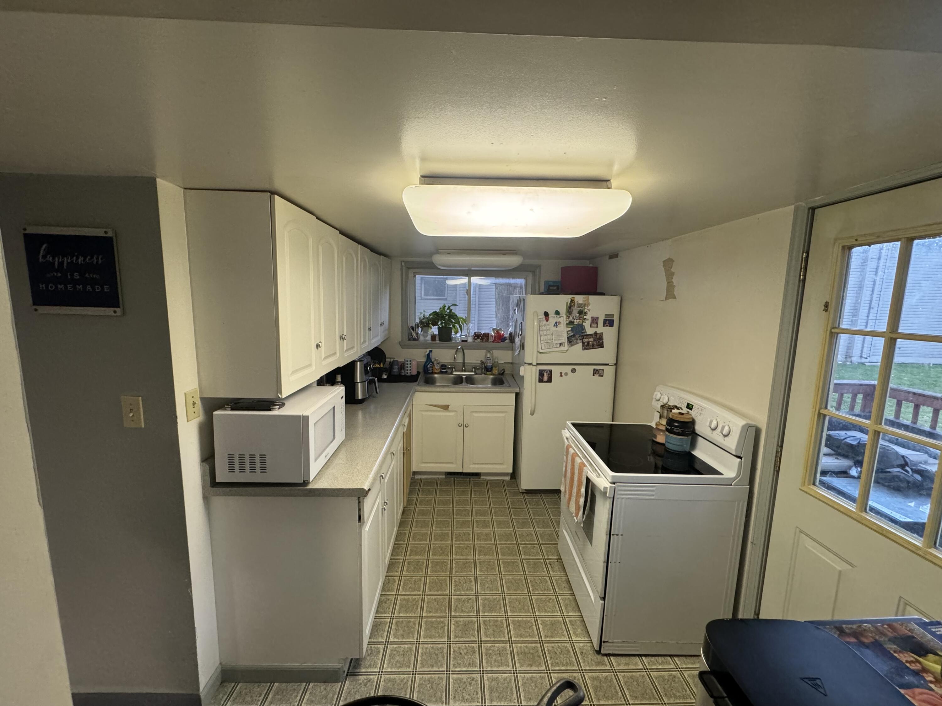 a kitchen with stainless steel appliances a refrigerator sink and cabinets