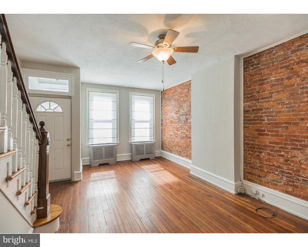 a view interior of a house wooden floor a chandelier fan and windows