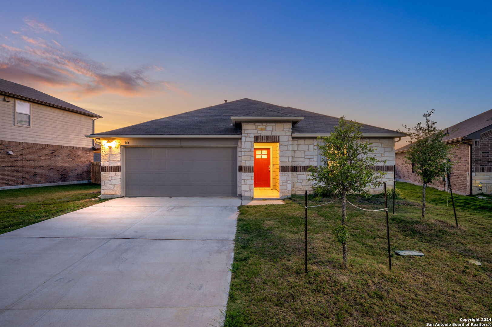 a front view of a house with a yard