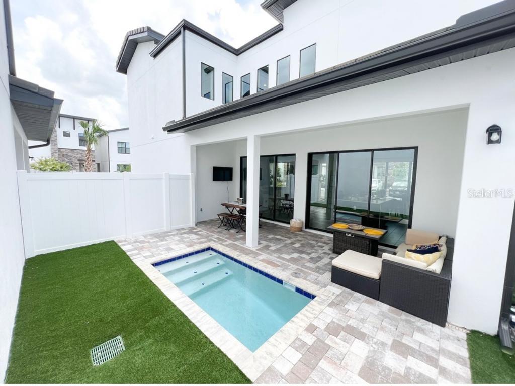 a view of an house with backyard porch and furniture