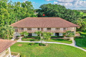 a aerial view of a house with swimming pool next to a big yard