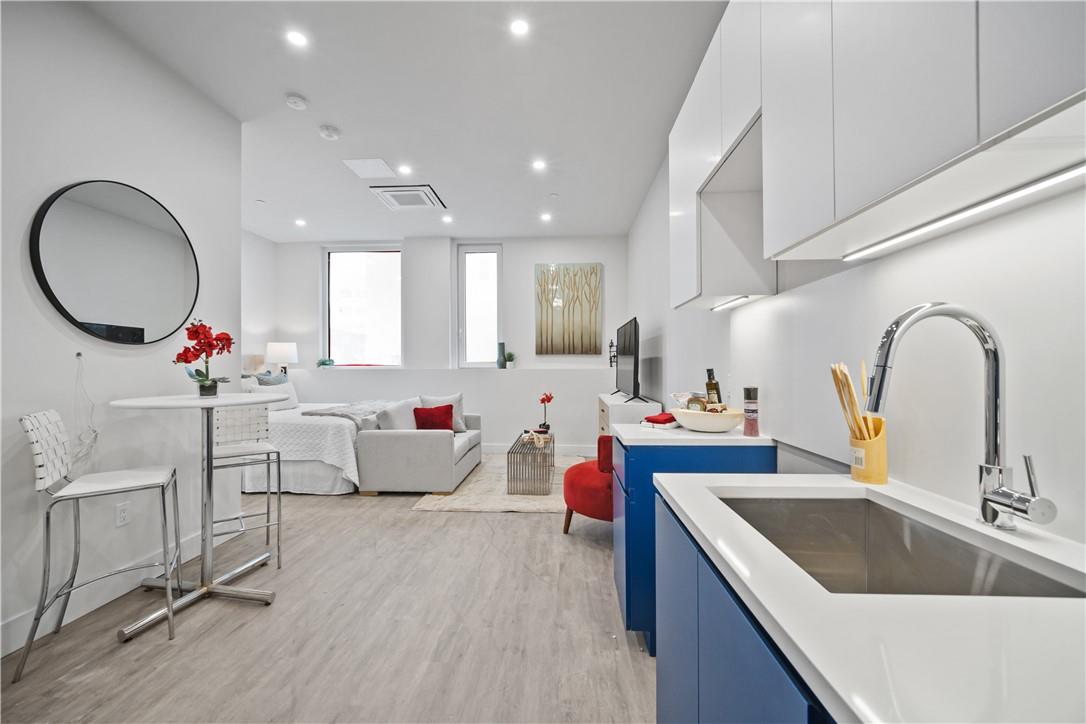 a kitchen with sink refrigerator and cabinets