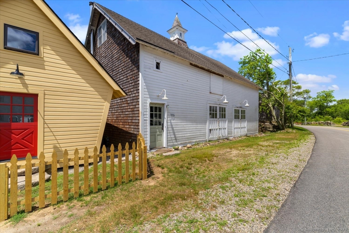 a view of house with backyard and tree