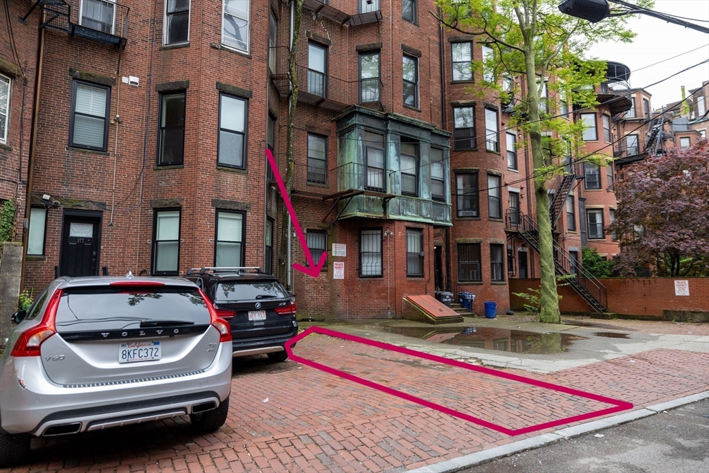 a car parked in front of a brick building