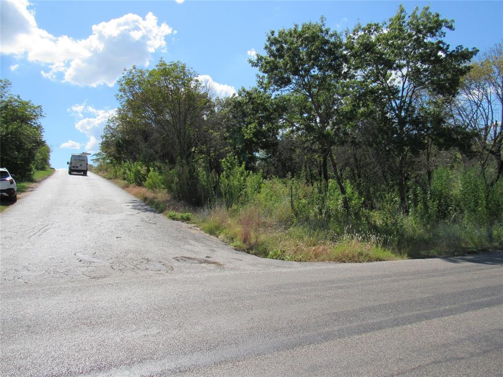 a view of a road with a yard