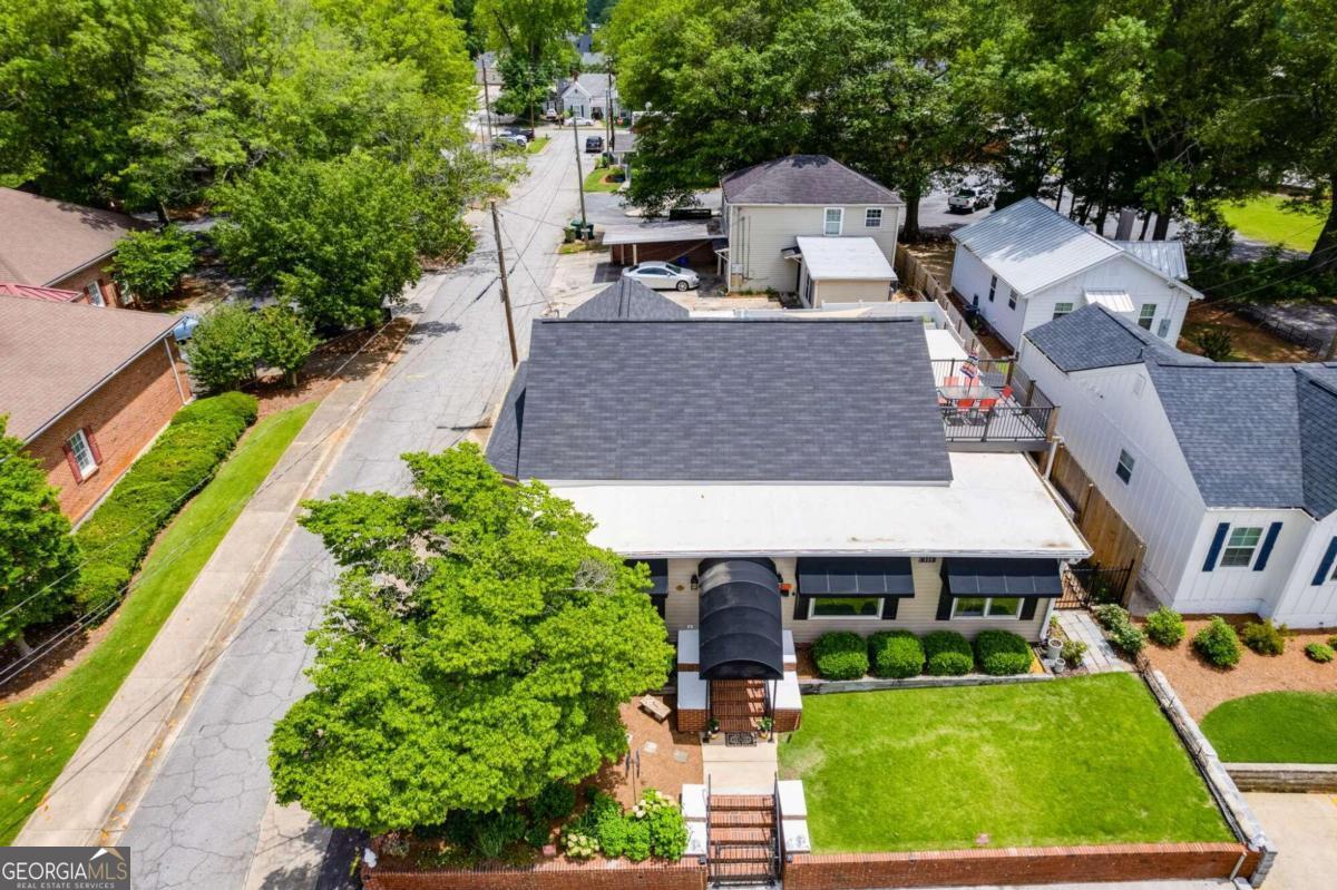 an aerial view of a house with a garden and plants