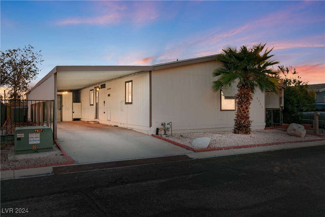 Dusk photo of the front of the home, showcasing th