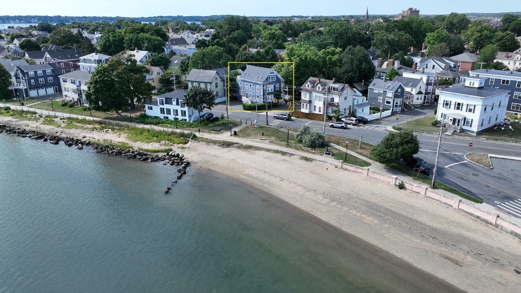 an aerial view of a house with a garden and lake view