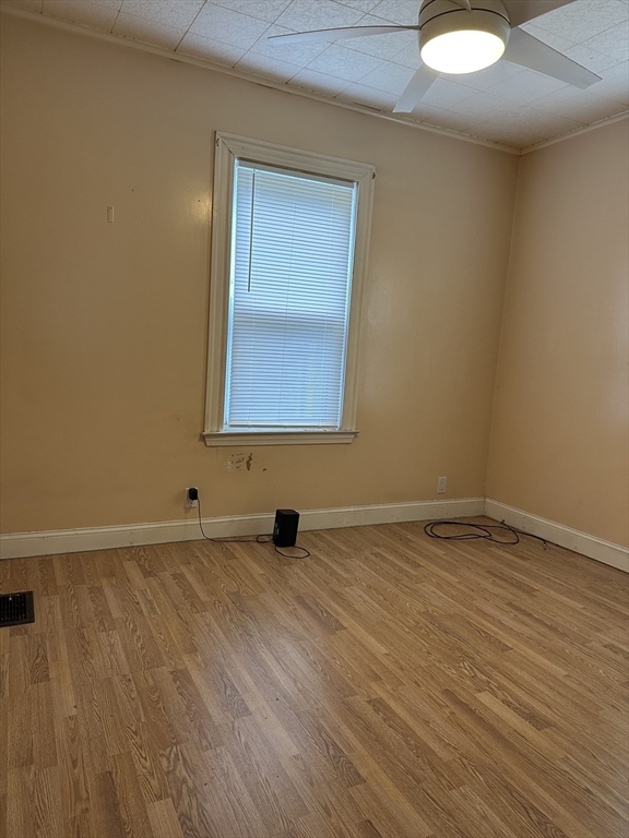 a view of an empty room and wooden floor