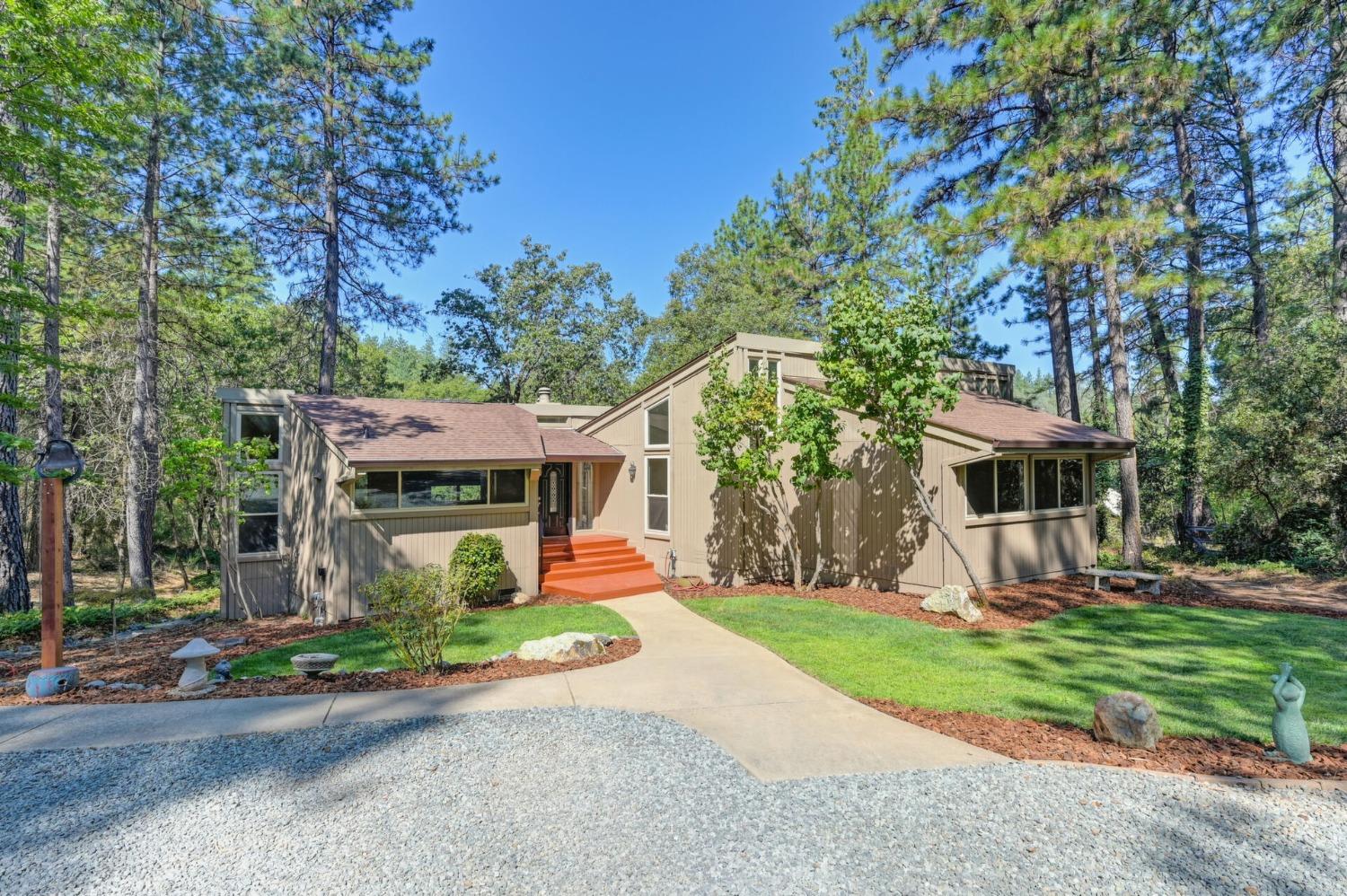 a front view of house with yard and green space