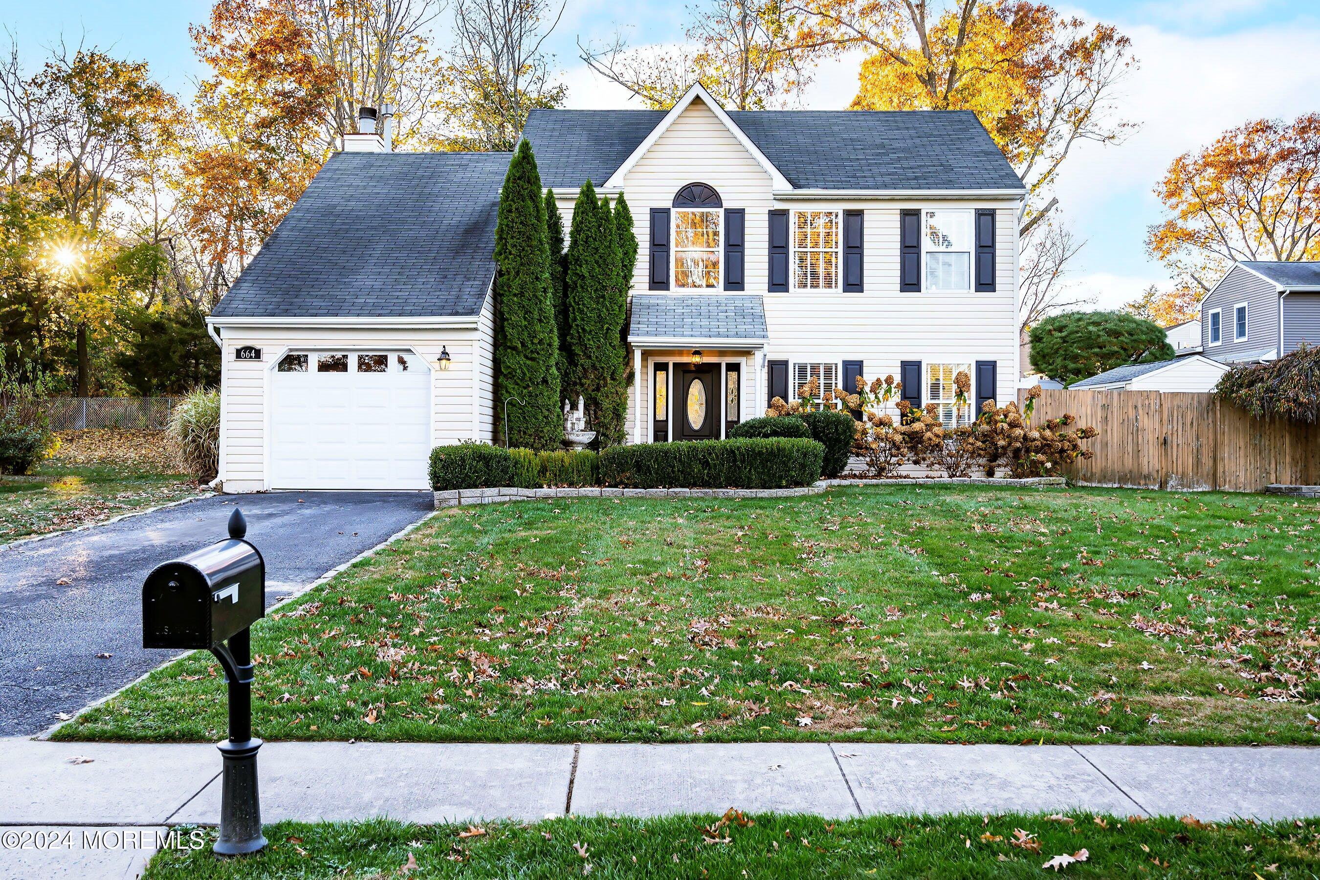 a front view of house with yard and green space