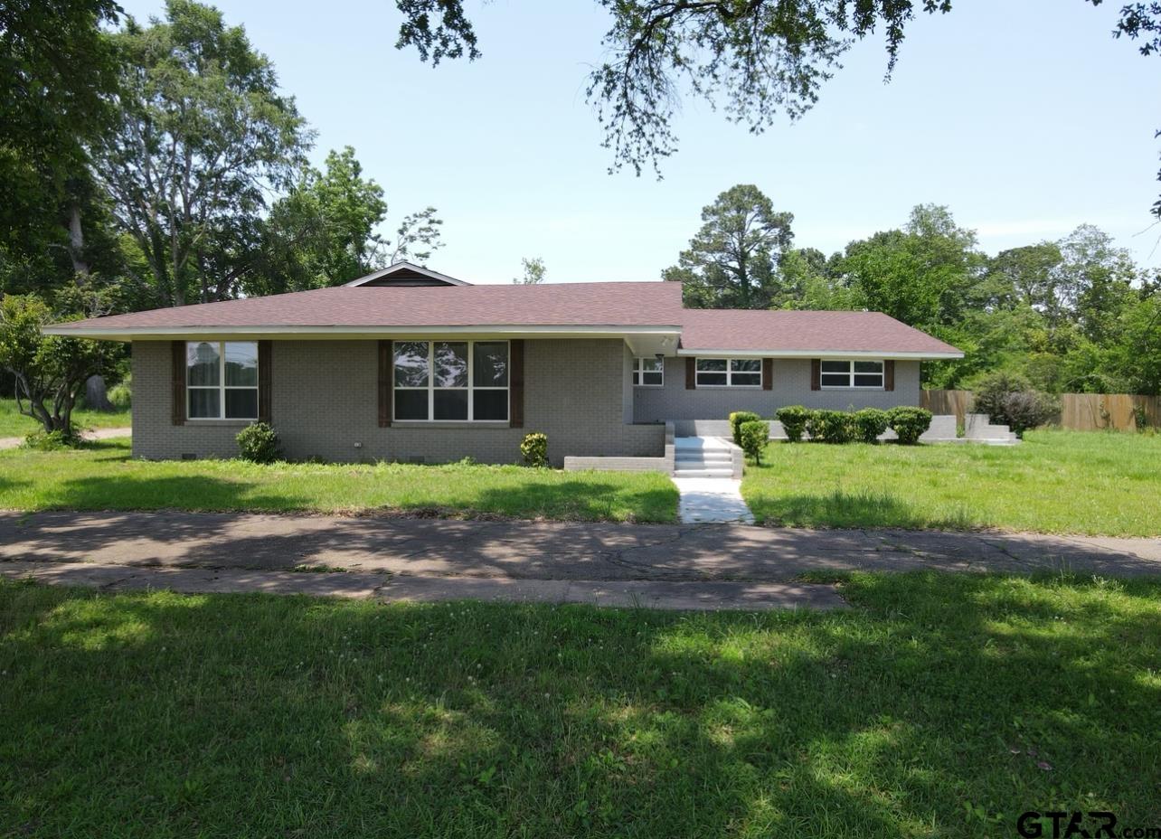 a view of house with yard and green space