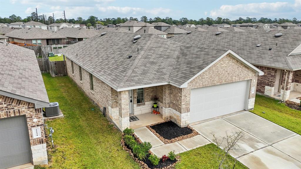 an aerial view of a house with a yard