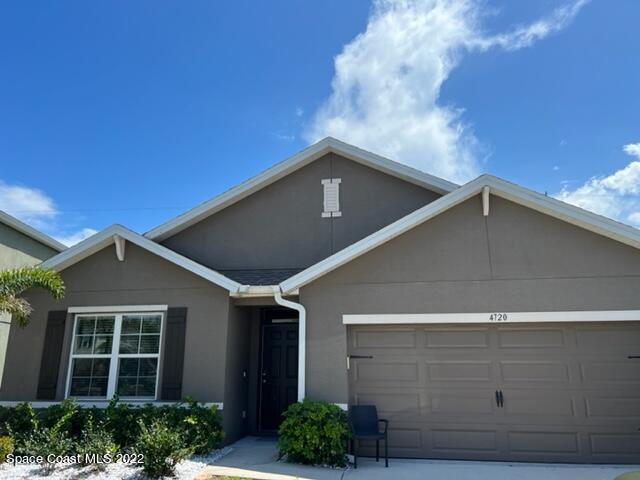 a front view of a house with garage