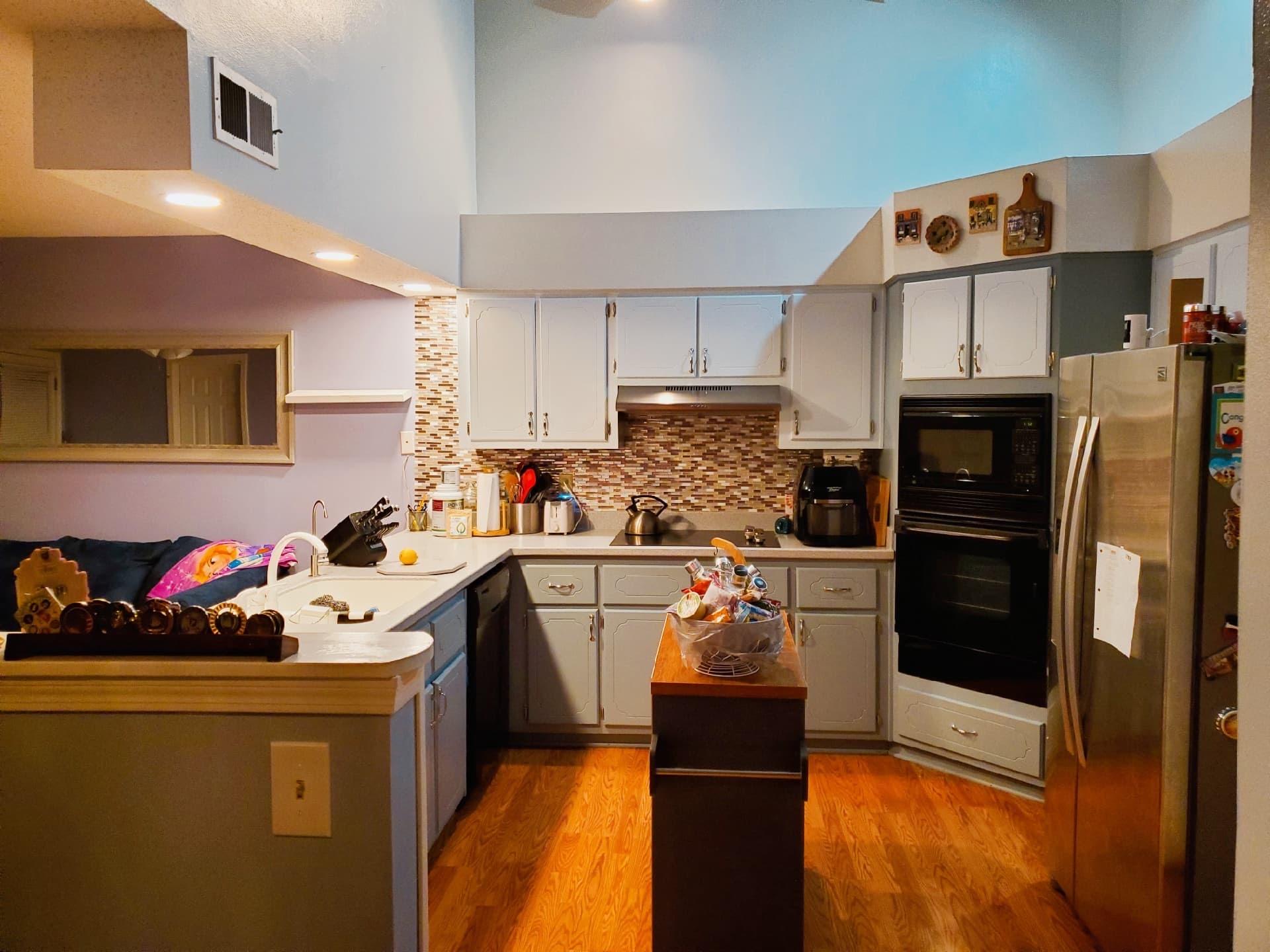 a kitchen with cabinets a sink and appliances