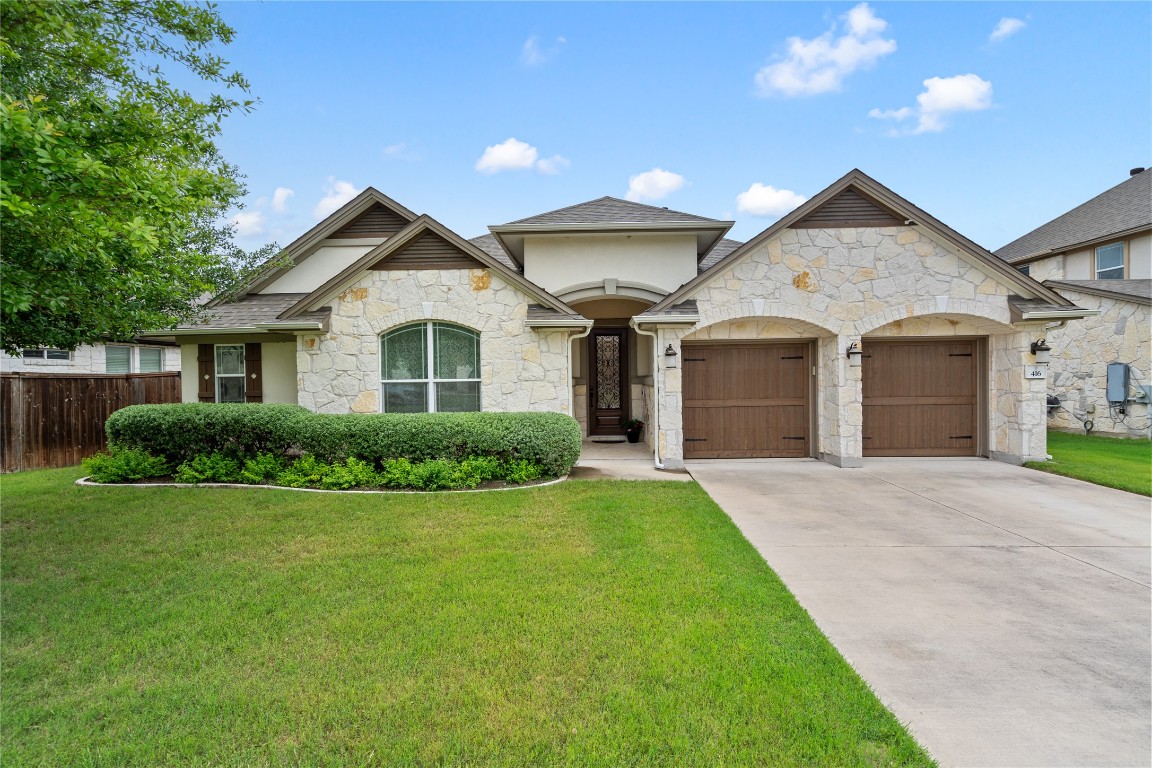 a front view of a house with a yard and garage