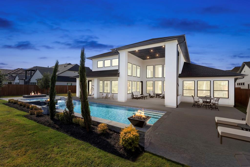 a view of a house with backyard porch and sitting area