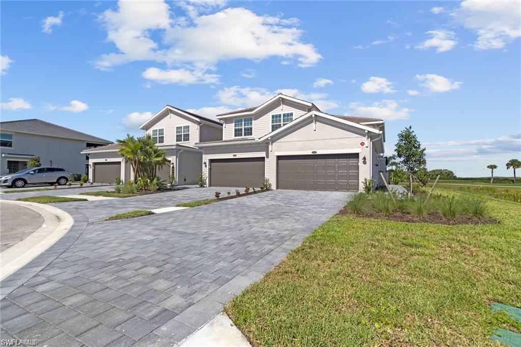 a front view of a house with a yard and garage