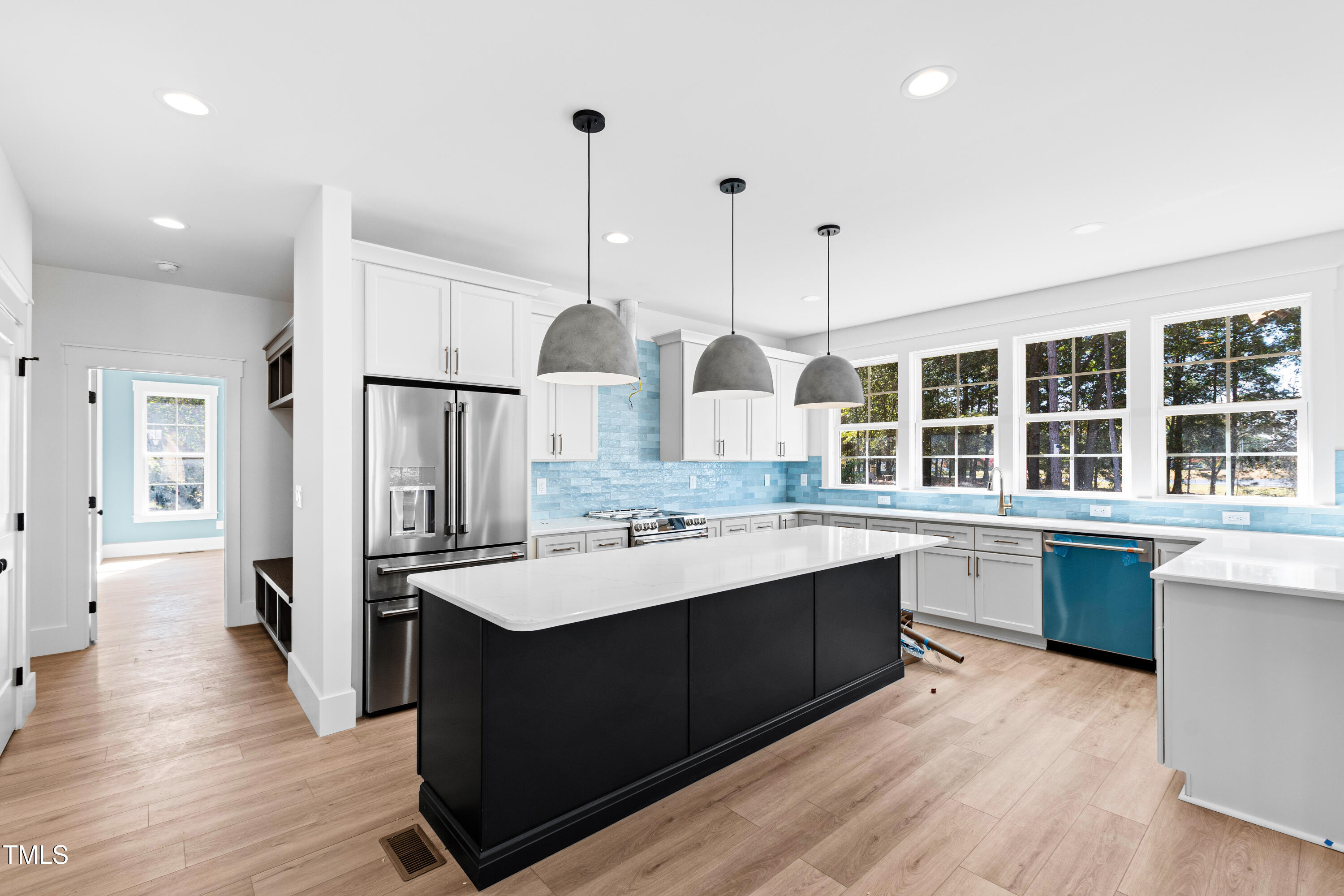 a kitchen with kitchen island a sink stove and wooden floor