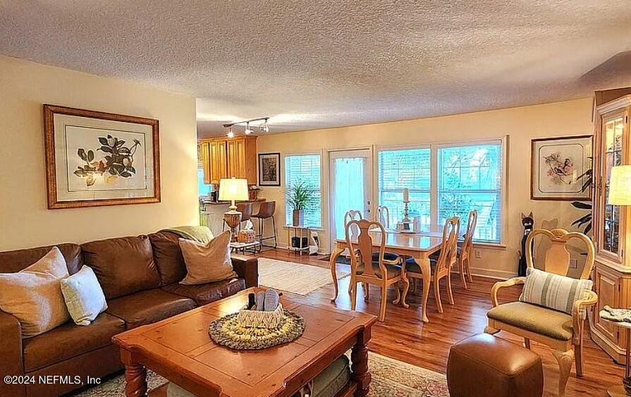 a living room with furniture and floor to ceiling windows