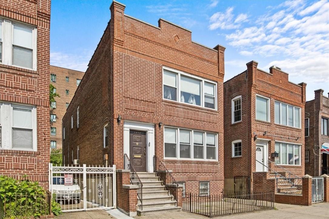 a front view of a residential apartment building with a yard