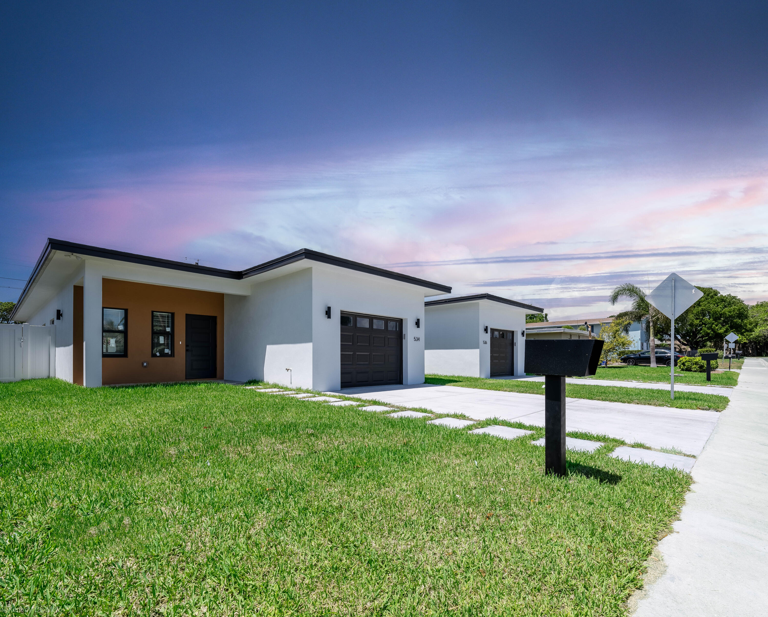 a house view with a sitting space and garden