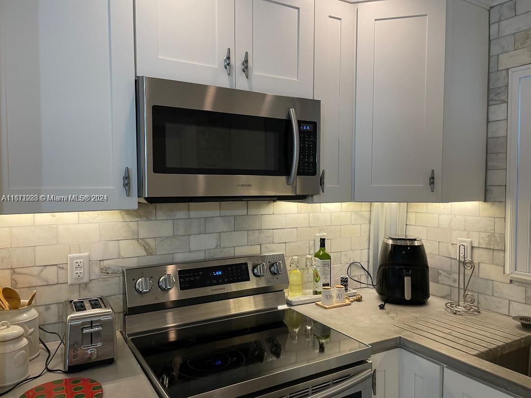 a kitchen with a stove and a microwave