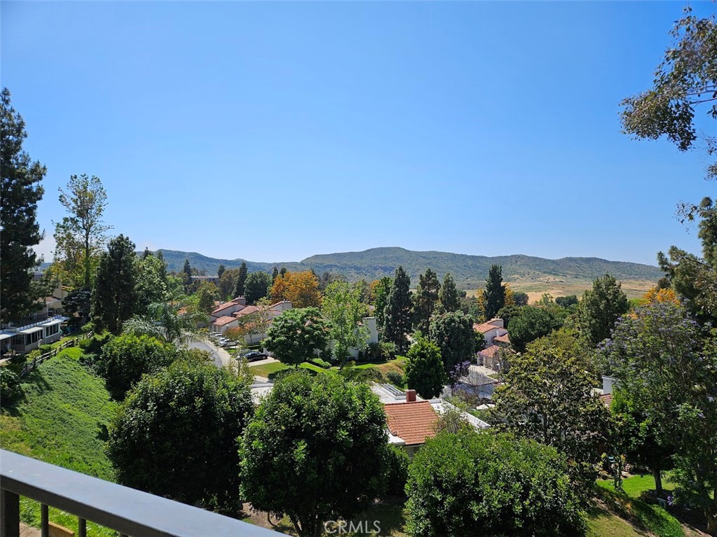 a view of a city with lush green forest