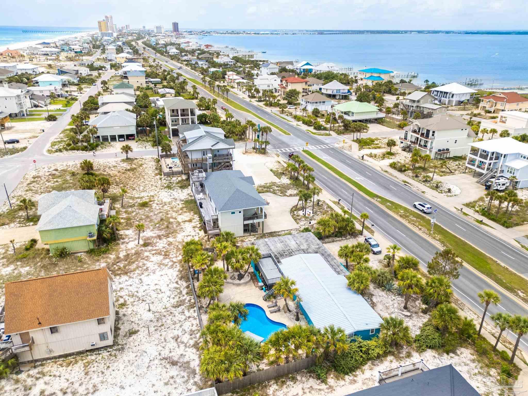 an aerial view of residential building and ocean view