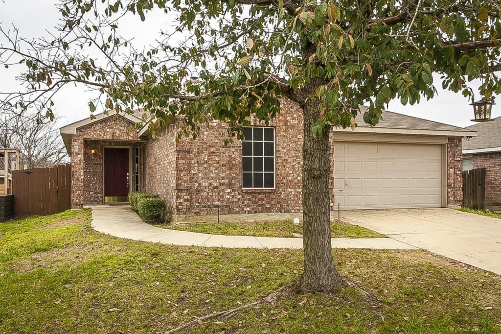 View of front of property featuring a front yard and a garage