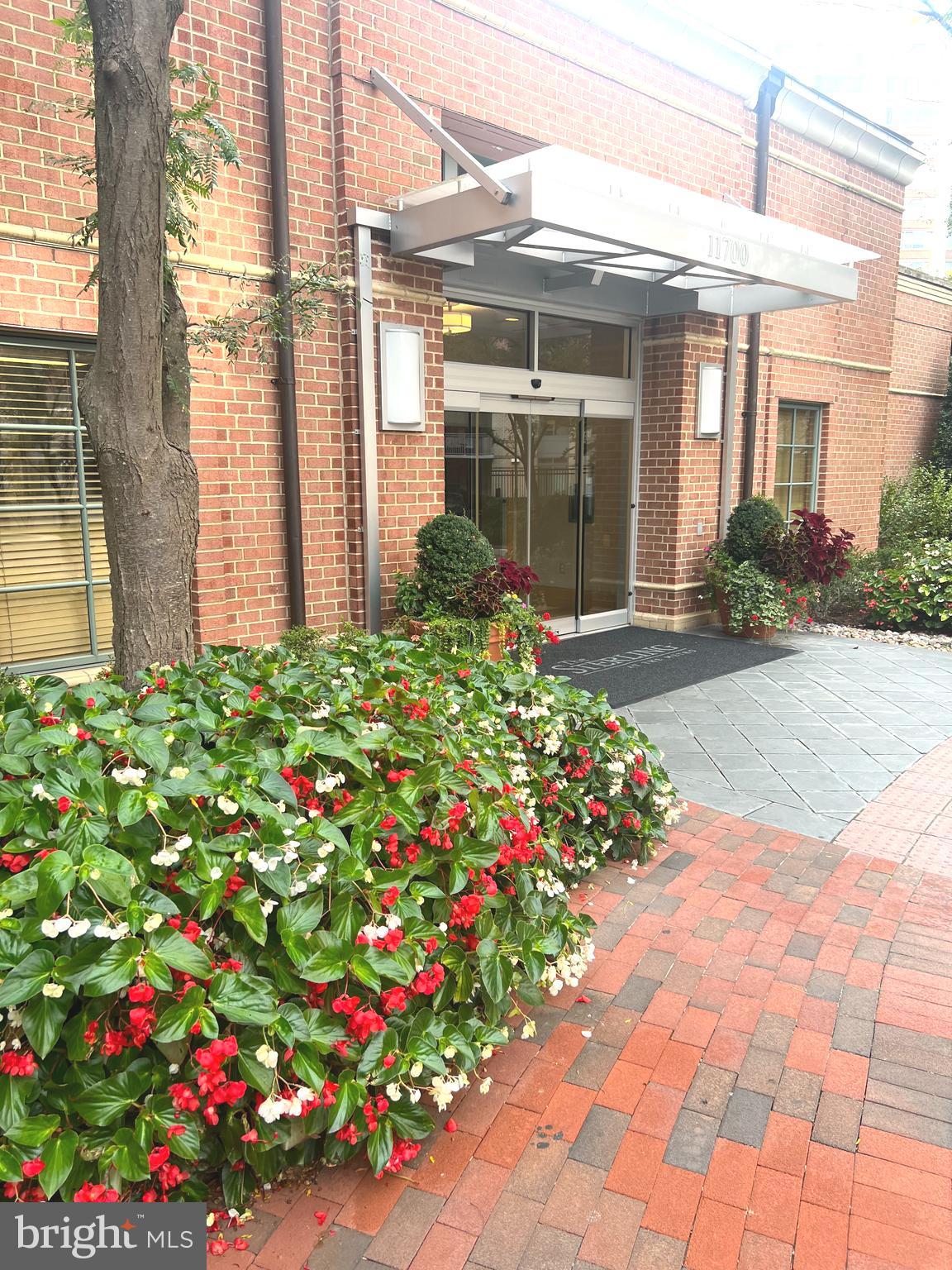 a front view of a house with flowers