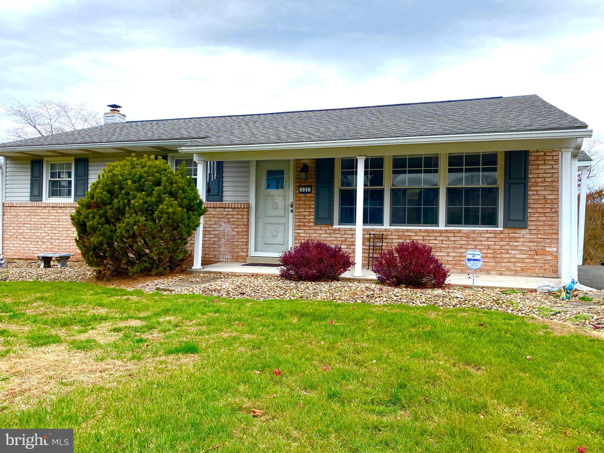 a front view of a house with a yard and porch