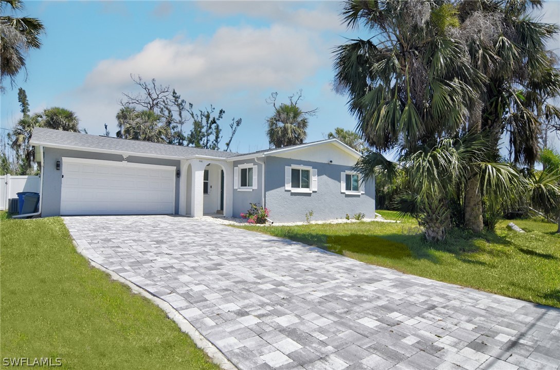 a front view of a house with a garden