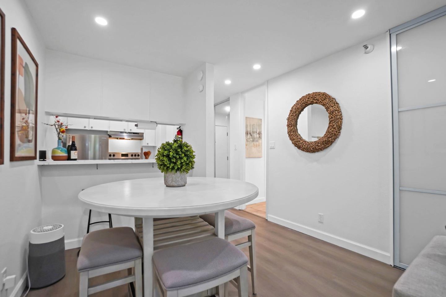 a view of a dining room with furniture and a potted plant