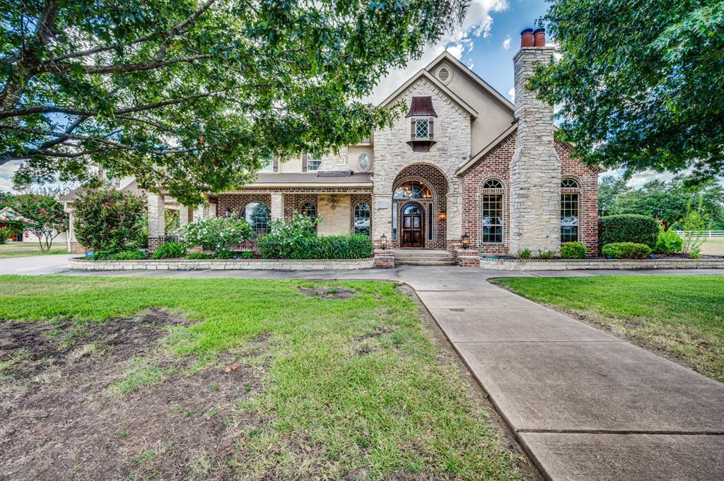 a front view of house with yard and green space