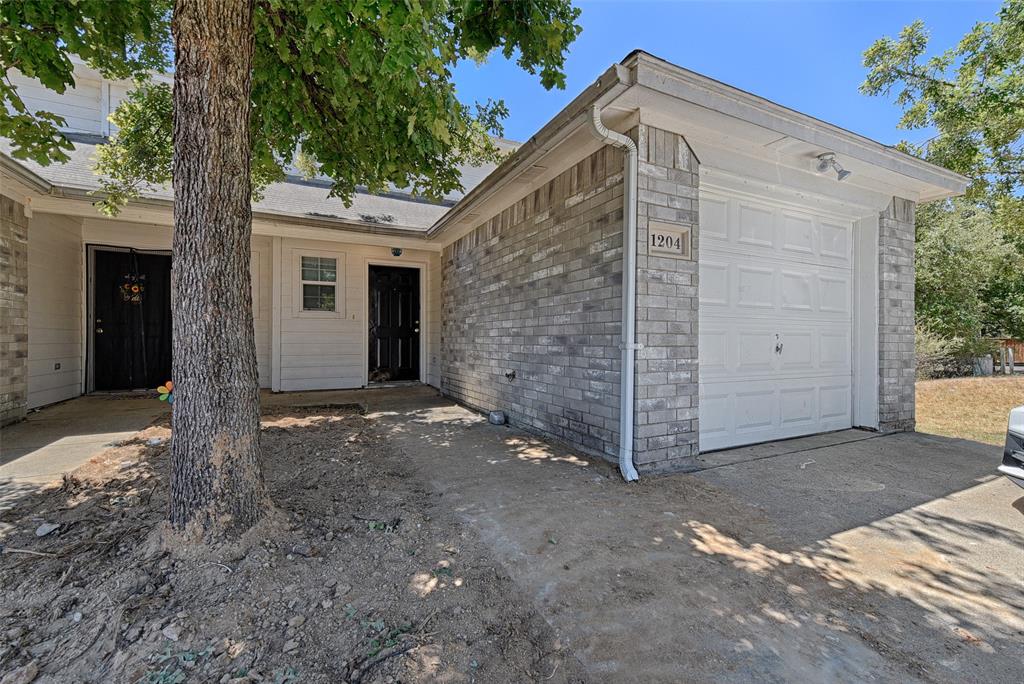 a view of a house with a yard and garage