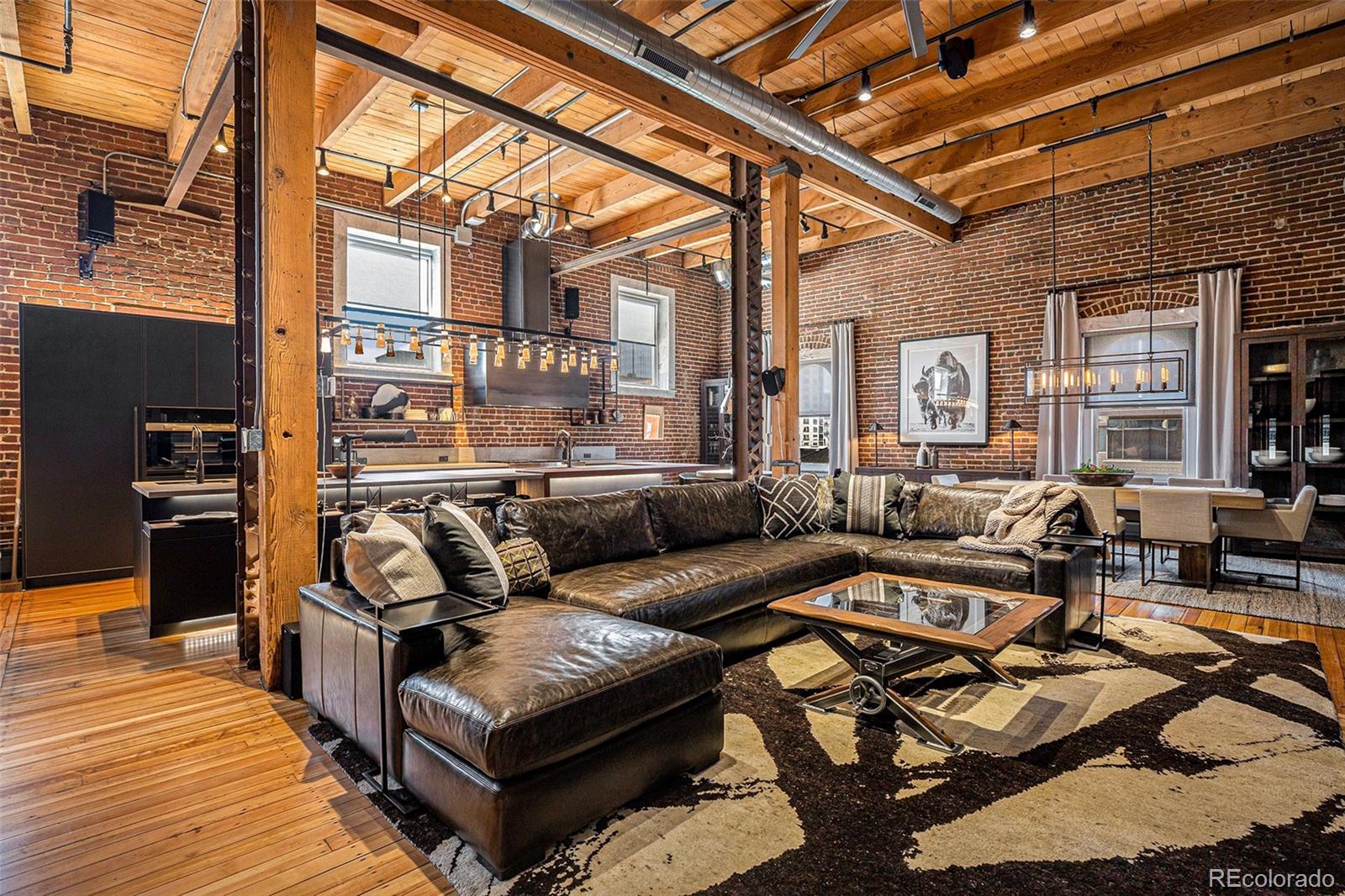 a view of a patio with couches chairs and wooden floor