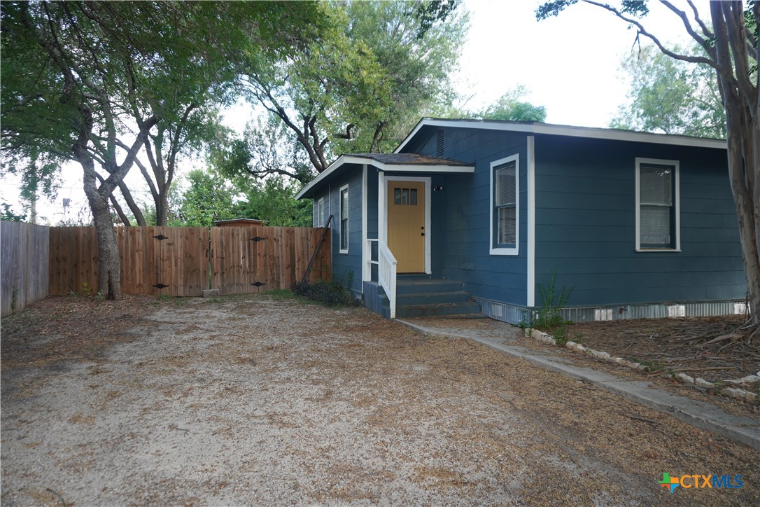 a view of a house with a backyard