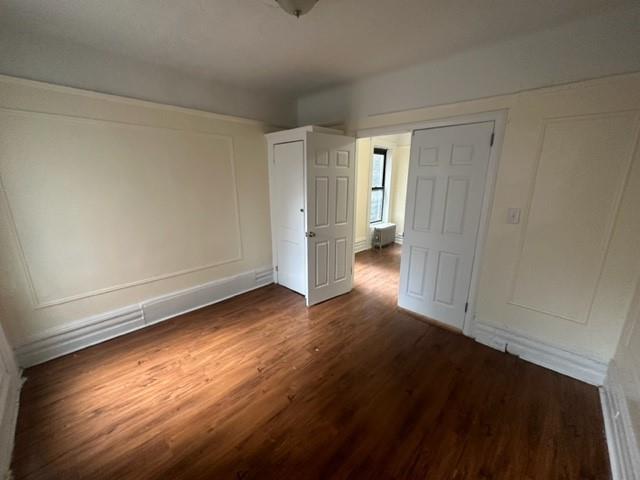 a view of an empty room and wooden floor