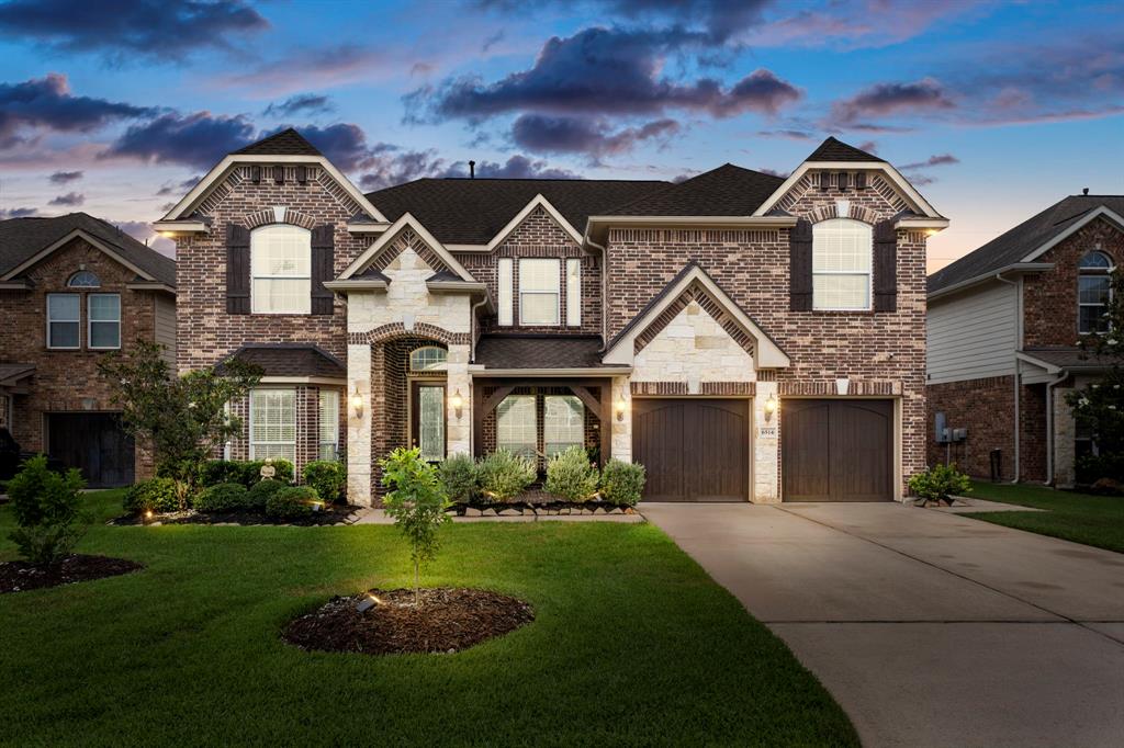 a front view of a house with a yard and garage