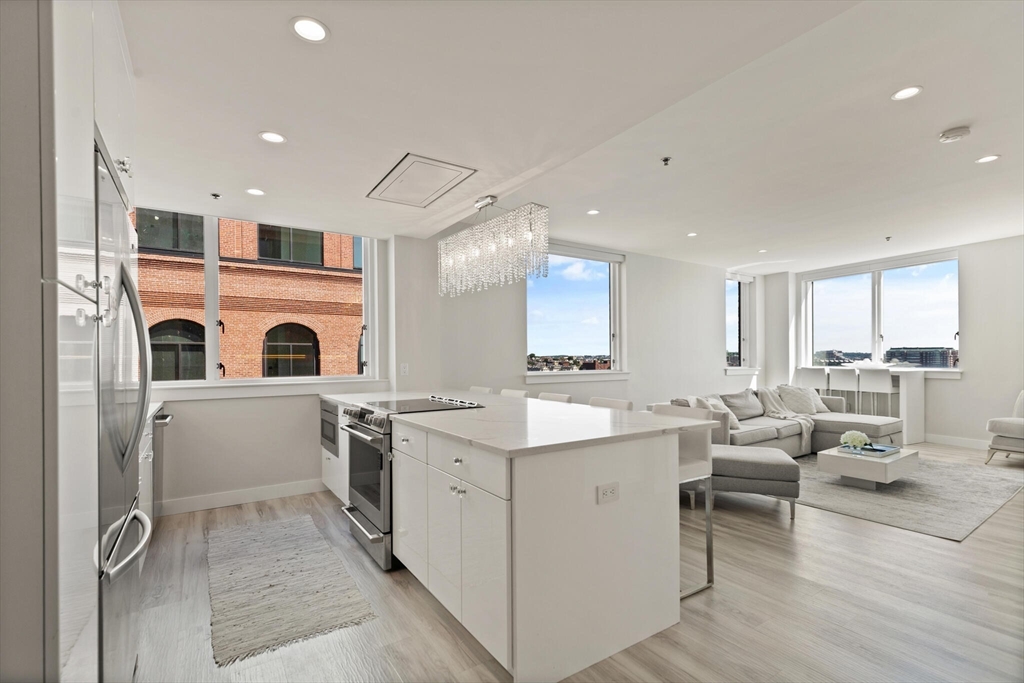 a kitchen with a sink counter top space and stainless steel appliances